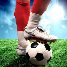 Cleats standing on Soccer ball