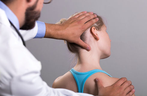 A chiropractor adjusting a patient's neck.