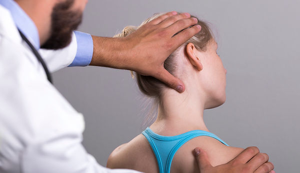 Chiropractor examining patient for neck pain treatment in oklahoma city