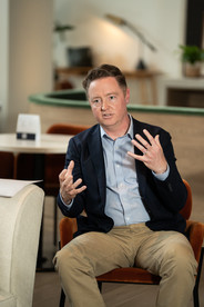 man sitting and speaking