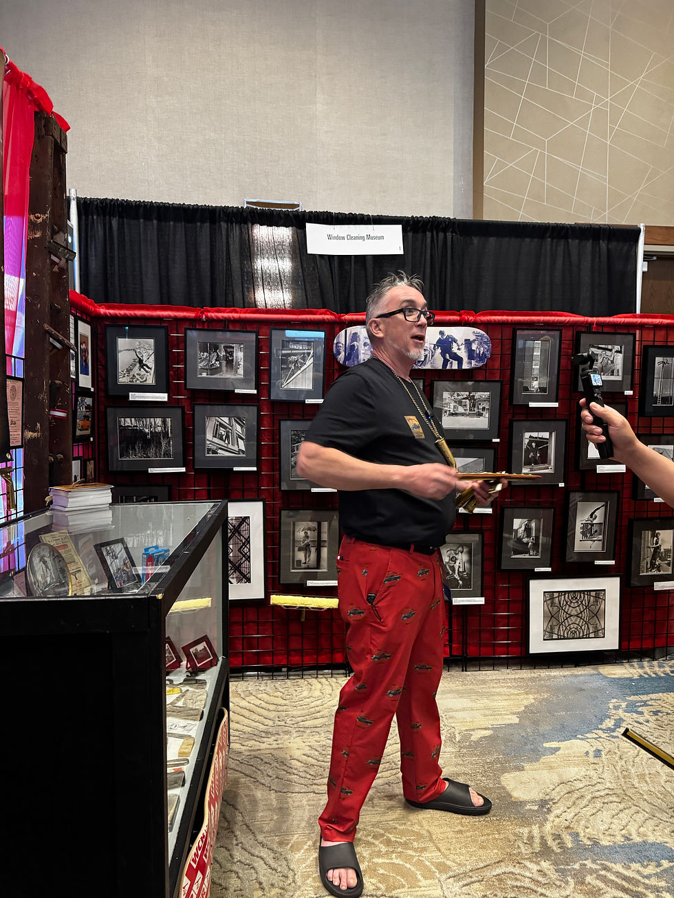 Craig Hendzel presenting at the Window Cleaning Museum exhibit, featuring vintage tools and historical photographs, at the IWCA 2026 convention. Ketchum Window Cleaning in the house.