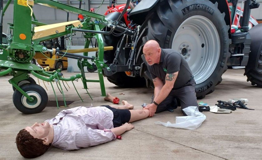 An instructor demonstrating on a mannequin in a first-aid course