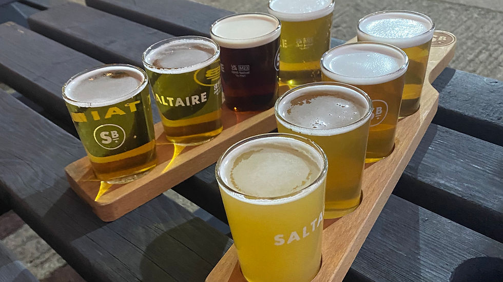 Two sets of flight boards from Saltaire Brewery. 4 third glasses on each, filled to the brim with beer.
