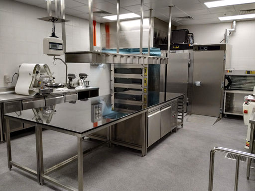 Professional hotel pastry kitchen with custom-designed workstations for pastry chefs.