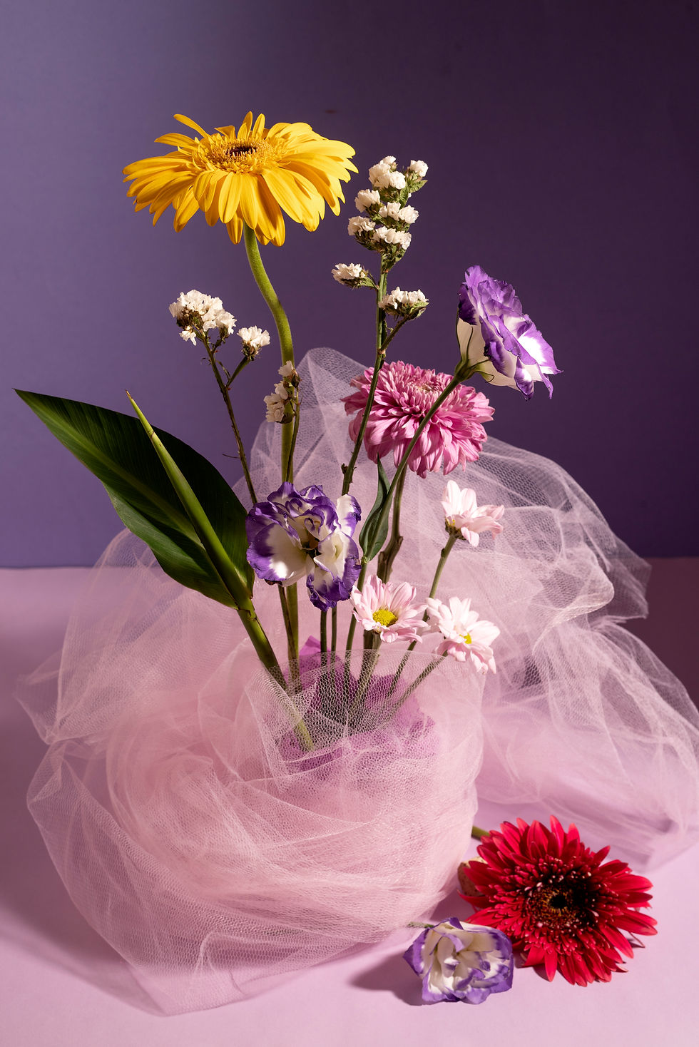 Close-up view of vibrant mixed bouquet with tulips and sunflowers
