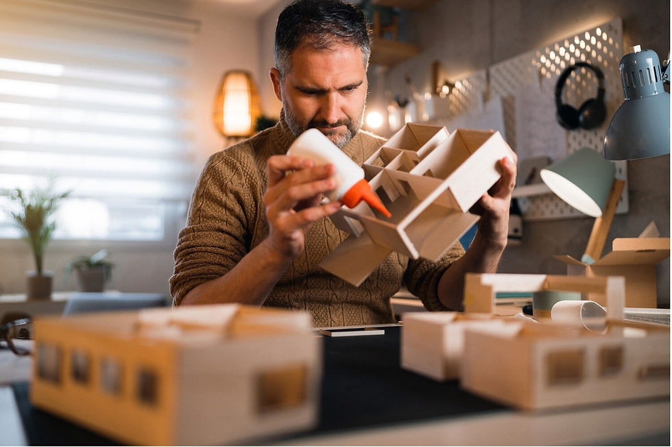 Man gluing a wood toy box together.