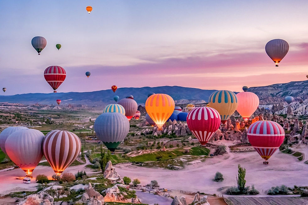 Hot air balloons floating into the sky.