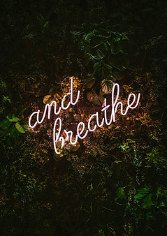 Photo by Max van den Oetelaar on Unsplash - neon sign that says And Breathe