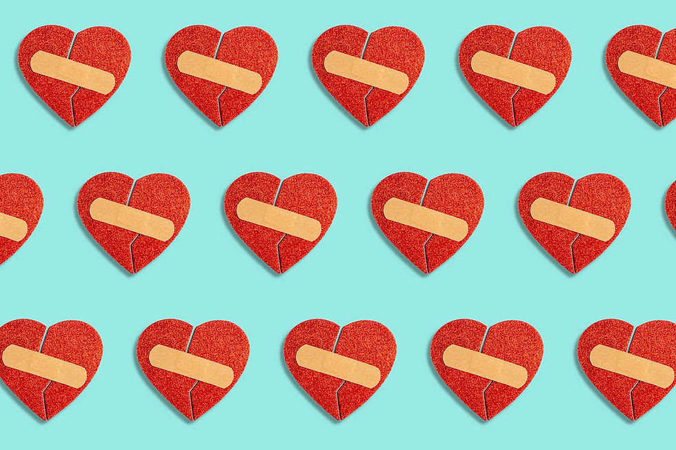 Three rows of broken red hearts with Band-Aids on blue background