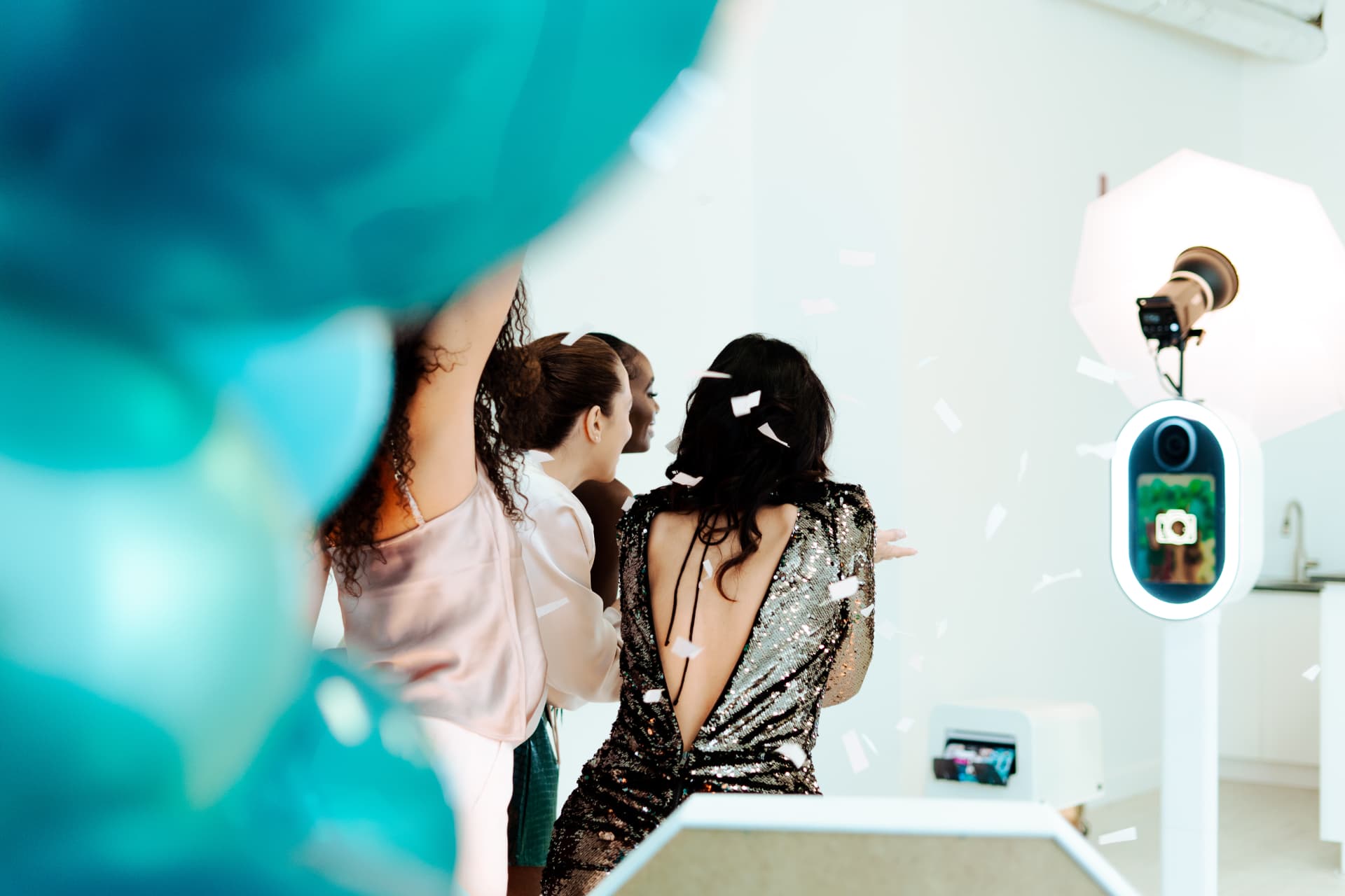 Guests laughing together during a PhiNik's MobiPix photo booth experience.