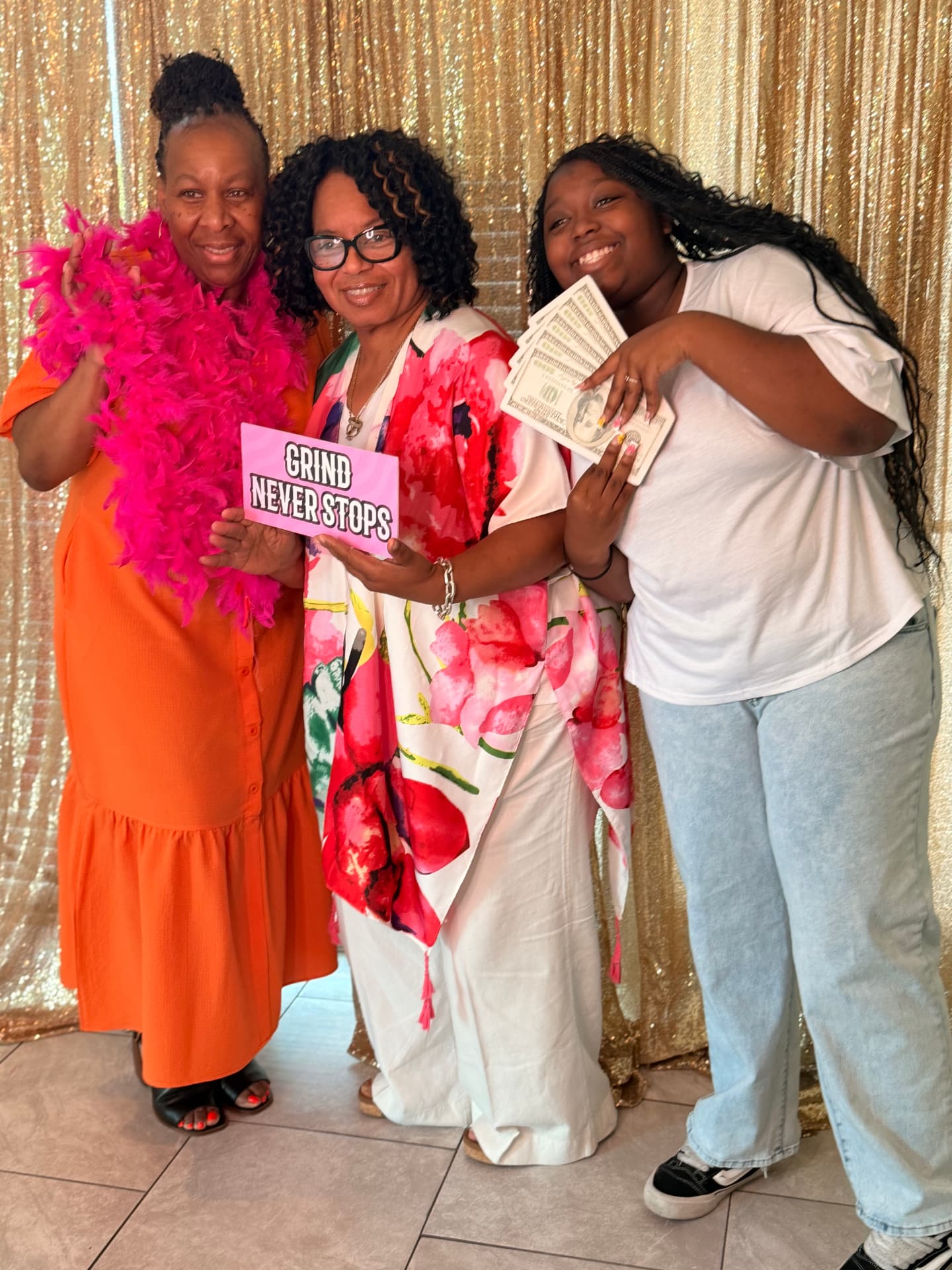 Family holding props at an open-air photo booth setup