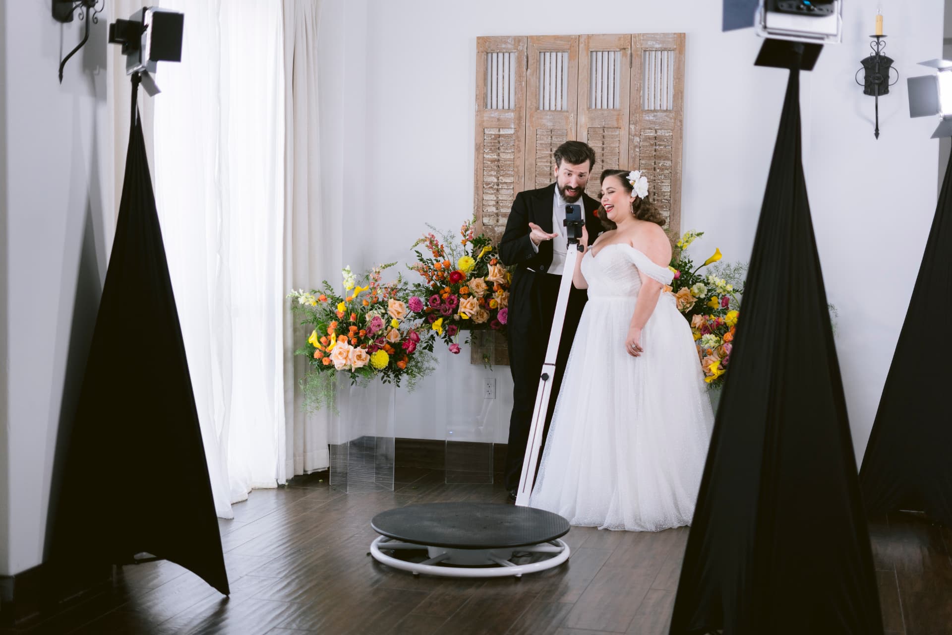 Wedding couple celebrating on the 360 video booth platform
