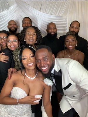 Wedding guests posing together at a PhiNik's MobiPix photo booth setup in Atlanta.