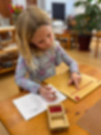 A child in the Primary classroom at work