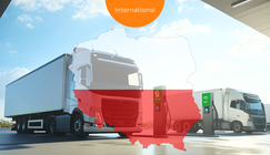 E-trucks loading on a depot. Poland Flag in the foreground.