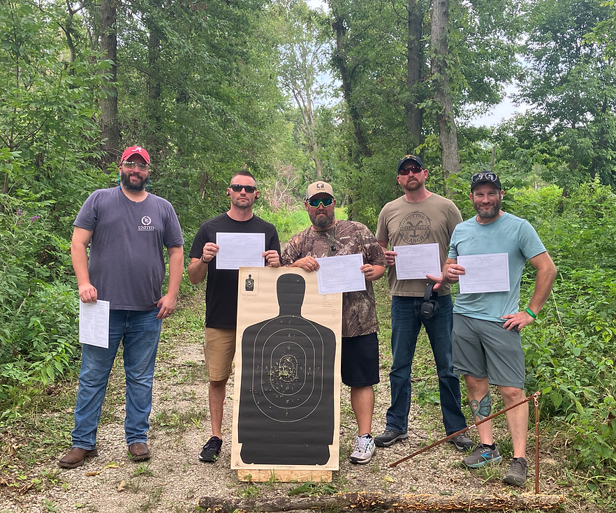 Students holding certificates after concealed carry training.