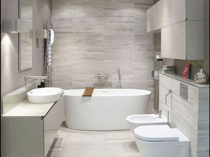 Modern bathroom renovation with a freestanding bath, vanity and tiled walls