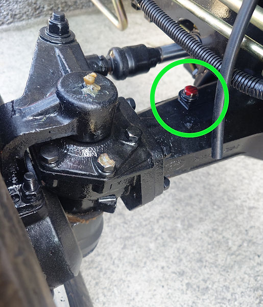 The front axle point is located on top of the front axle. There is usually a fill point on both sides, one having a breather and one being a dipstick, however both can be used to fill the front alxe. 
The engine oil used should be Hypo 80W/90 gear oil.
