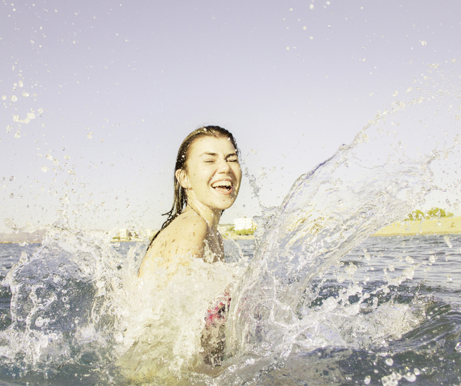 women laughing in water