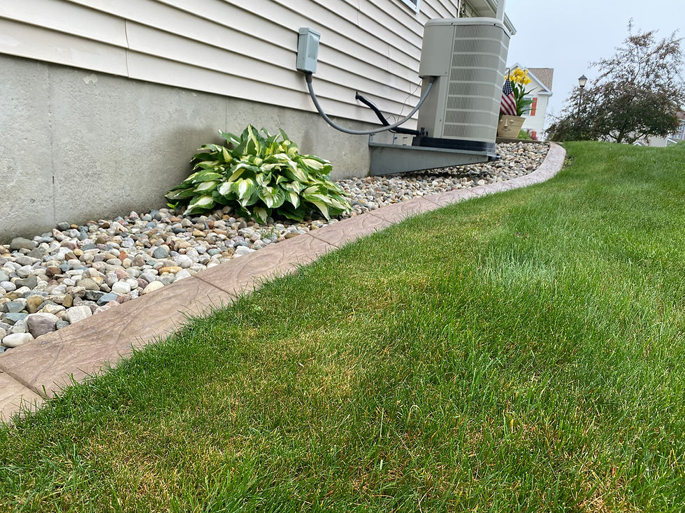 concrete curbing around a ac unit on the side of a house