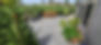 Residential paver patio with dining set and landscaping