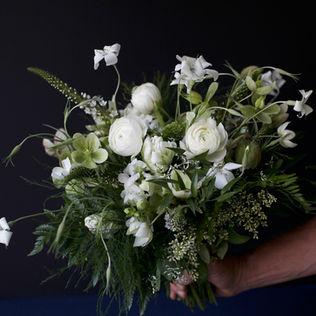 Loose white and green wedding bouquet with seasonal flowers, ferns and textural greenery by Amelia Island floral studio The Heirloom Yard.