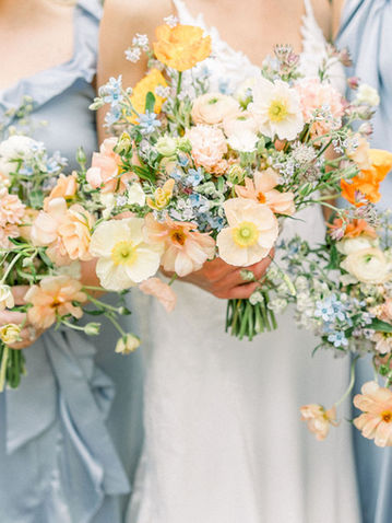 bride and three bridesmaids holding their spring flower bouquets