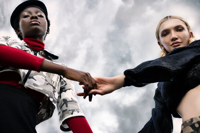 Two woman in typical herero fashion style shaking hand