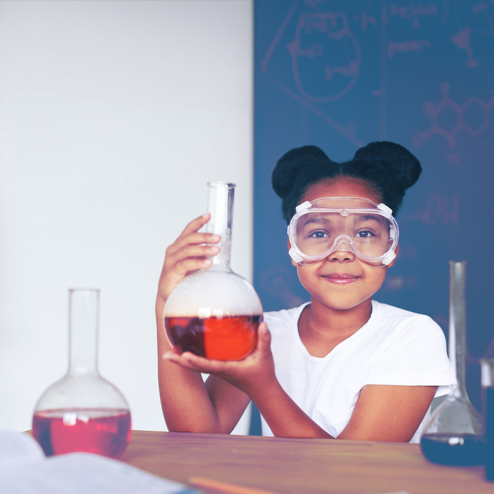 Young child holding up beaker and wearing protective goggles