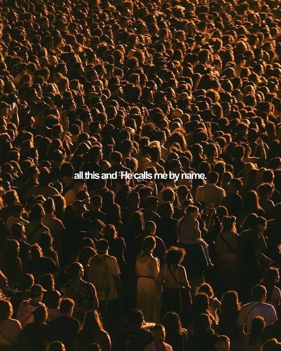 Crowd of people in warm lighting. Text reads: "all this and He calls me by name." Mood is introspective and contemplative.