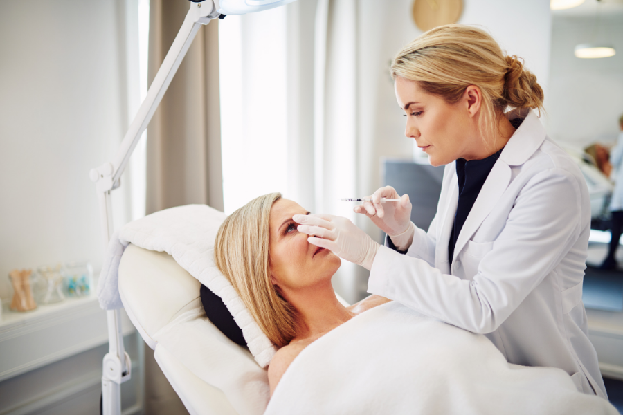 doctor treating patient in cosmetic clinic