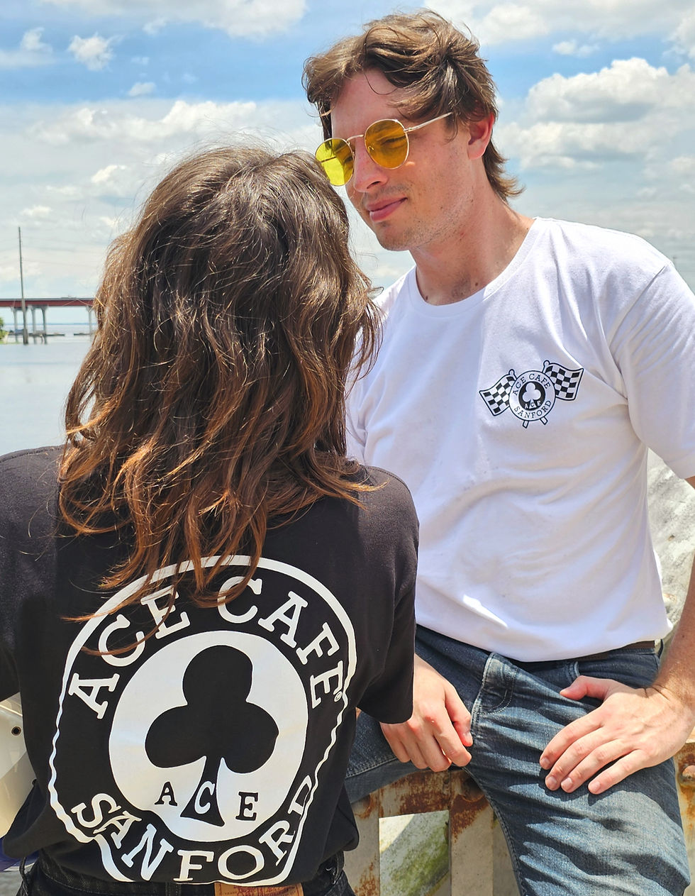Thumbnail: Man and woman wearing Ace Cafe Sanford black tees one black one white