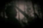 alex blecker, holding a guitar against his forehead eye closed, in the forest, an introspective way
