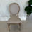 Thumbnail: King Louis antique chair rental with carved wooden frame and taupe upholstered seat and back, perfect for elegant weddings