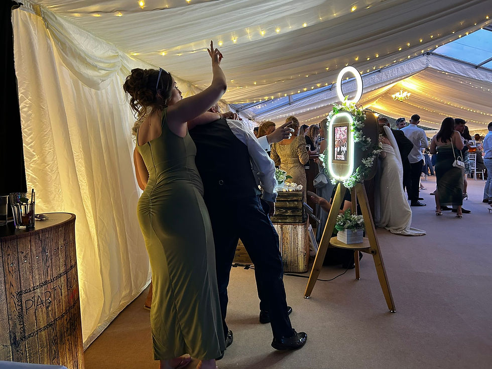 High angle view of wedding guests using a photo booth with props in a Cheshire venue