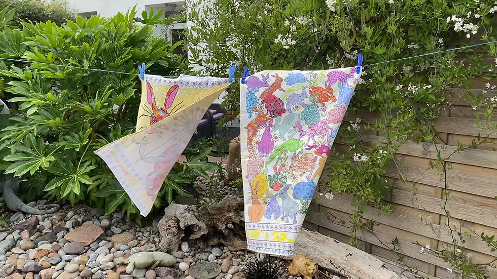 Thumbnail: rabbit tea towel and flick of hares kitchen towel on a washing line in a garden
