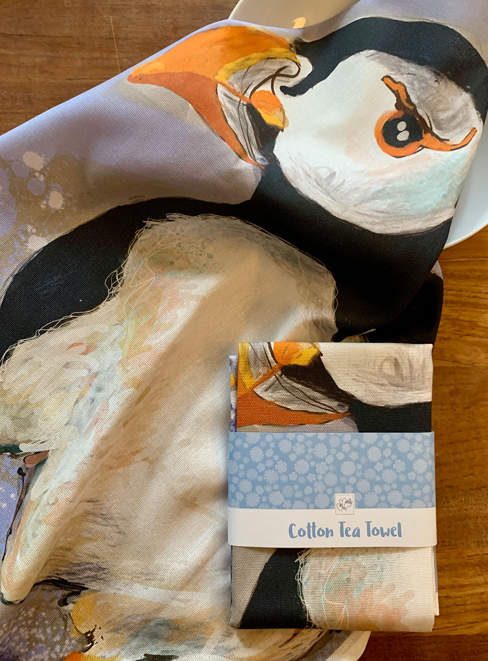 Thumbnail: A large black and white puffin with a cheeky look splashing about in the sea