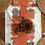 Thumbnail: Burnt Orange Table Runner, depicting homes, trees and people walking down the road