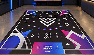 Custom reverse printed vinyl floor with colorful geometric graphics and branding for a virtual reality gaming event.