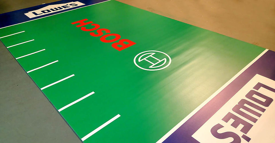 Custom TPV flooring in green with Bosch logo for a branded event display
