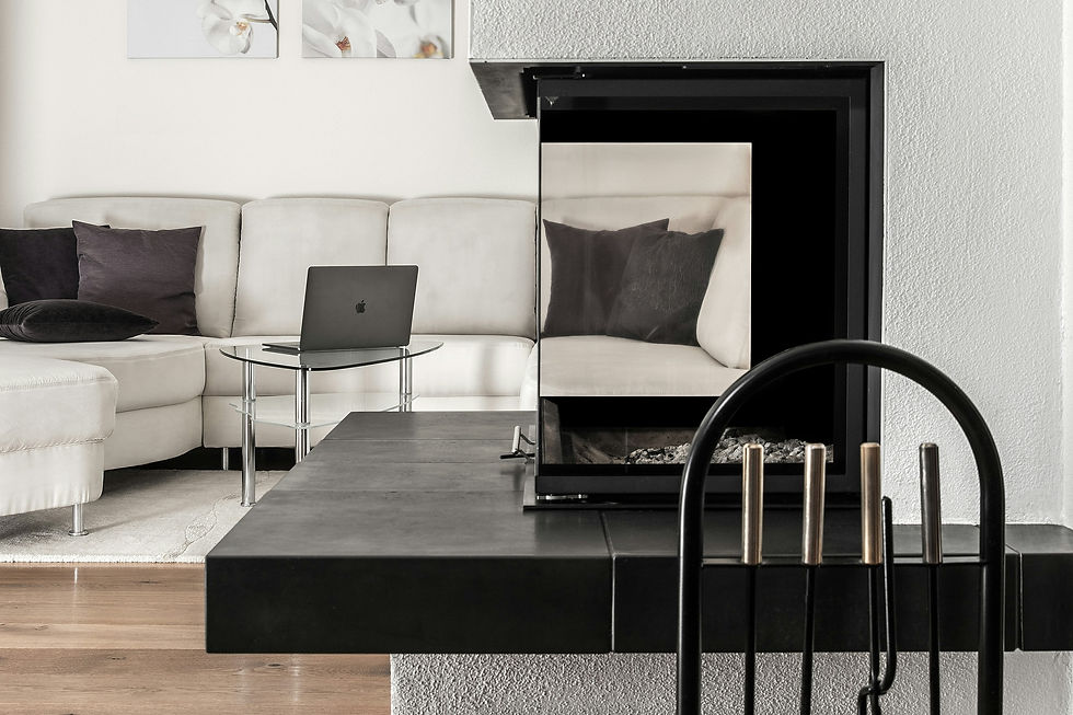 Modern living room with cozy white couch and laptop on glass table