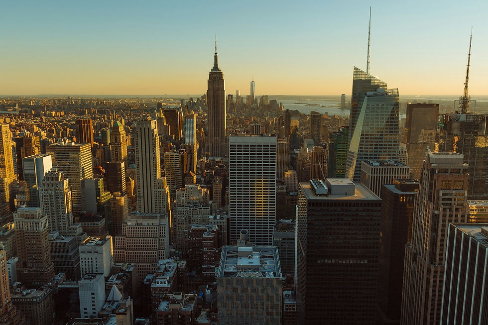 Morning light bathes the New York City skyline seen from an elevated perspective