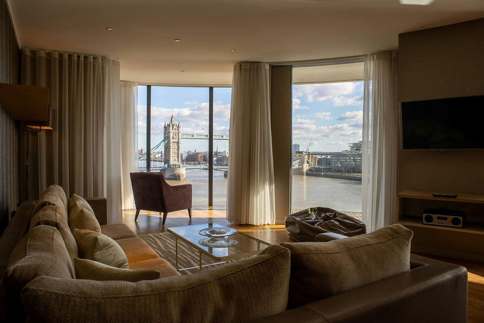 Luxury apartment living room with large windows overlooking Tower Bridge in London