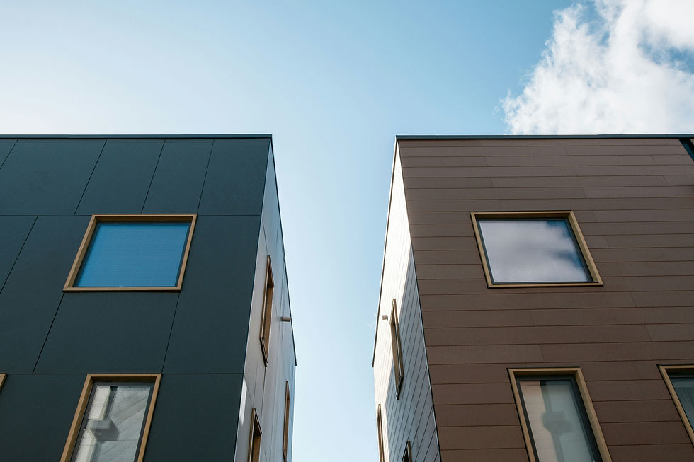 Looking up at the sky between two contrasting modern buildings