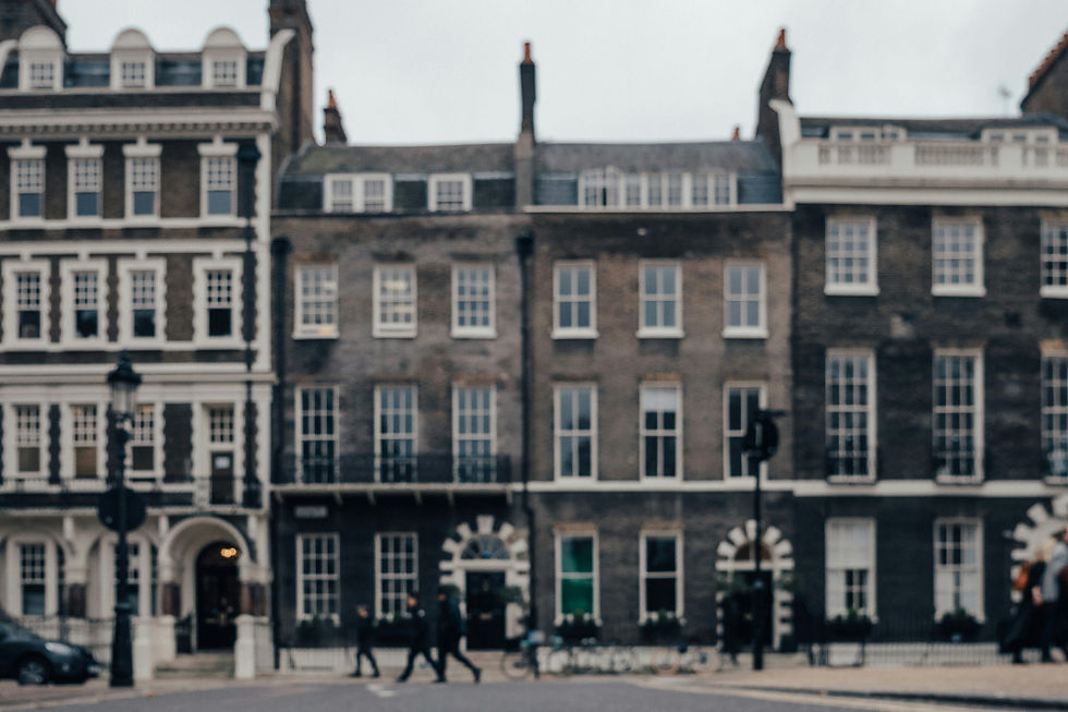 A low-angle view of Georgian townhouses in a London square, emphasizing the historical charm and architectural detail