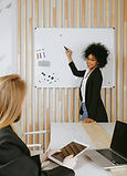 woman-pointing-at-whiteboard-3727511 (1)