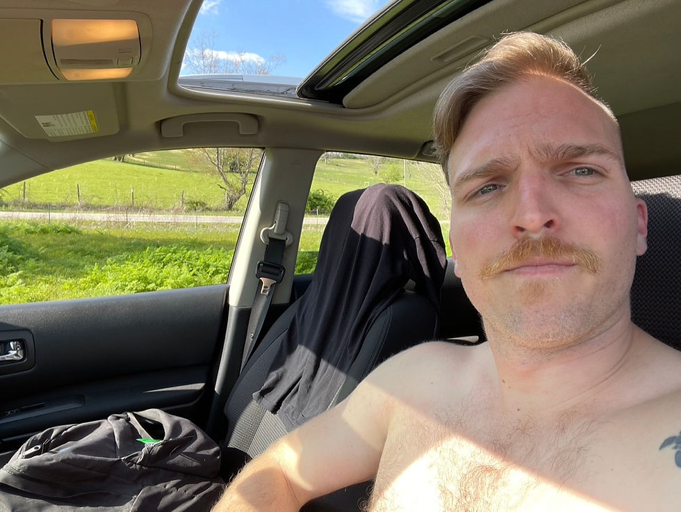 Dillan Taylor sunbathing in his broken-down car