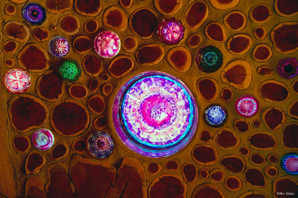 Colorful glass orbs embedded in wooden wall