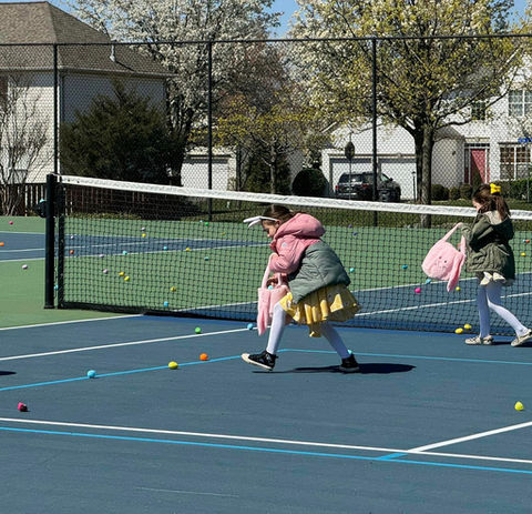 Cascades Park Community Association HOA Annual Egg Hunt. Kids on tennis court finding eggs.