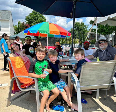 Family enjoying a snack at Cascades Park swimming pool.